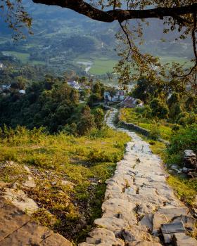 A colour photo of a rocky set of steps leading down the mountainside. Pokhara, Nepal, 2009.