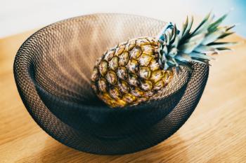 A pineapple. in a bowl of wire mesh. It's nothing special really, I just liked the textures and the patterns in the mesh.