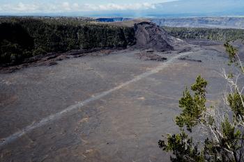 The Kilauea Iki trail from above, showing people walking accross the crater lava lake