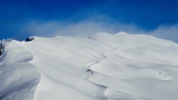 A snowly landscape under a clear blue sky