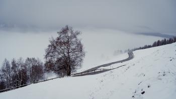 A winding road along a foggy valley
