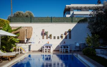 A swimming pool, with a couple of tables and a wall behind. The geometry is nice.