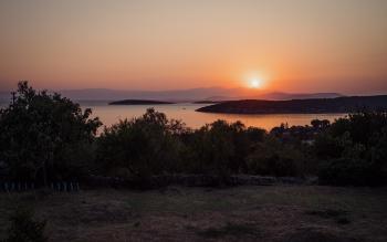 Sun setting over the mountains in the distance